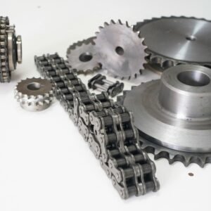 Detailed close-up of motorcycle mechanical gear parts and chains on a white background.