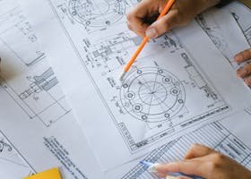 From above of crop anonymous businesspeople discussing project on papers at table of office in daytime